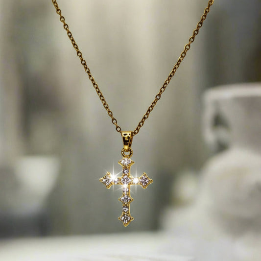 Gold cross necklace on a white bust