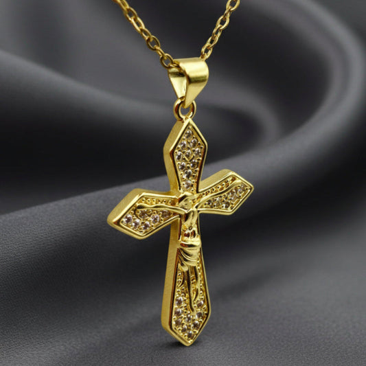 Gold cross pendant necklace on a white background