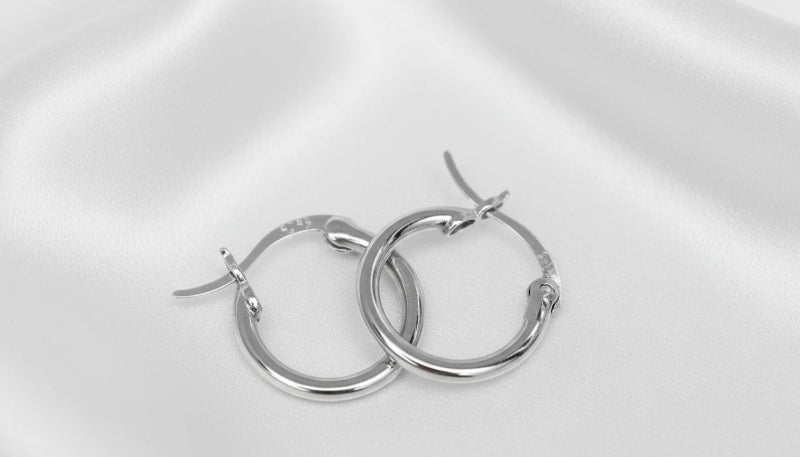 Pair of silver hoop earrings on a white background