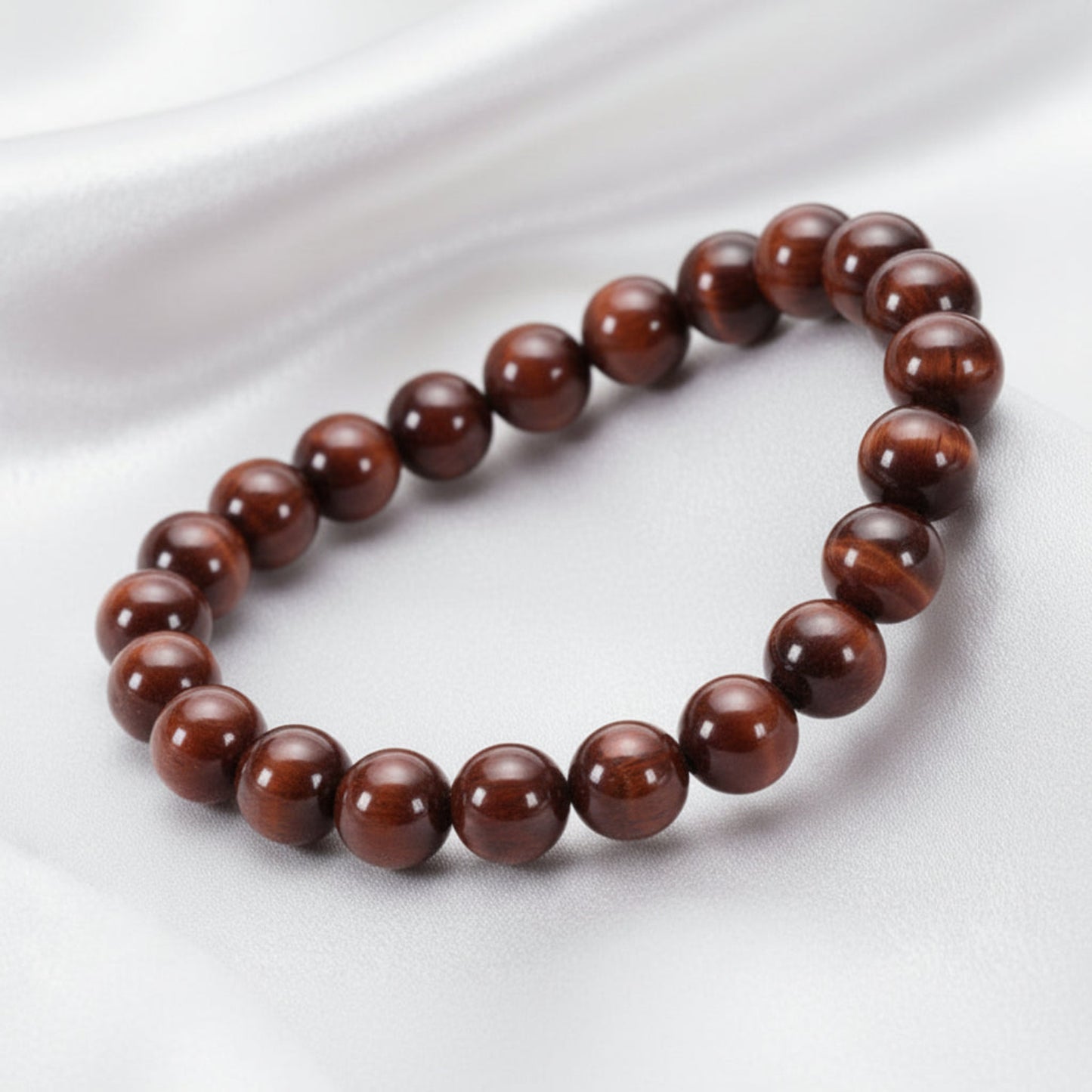 Bracelet made of natural red tiger eye beads on a white background