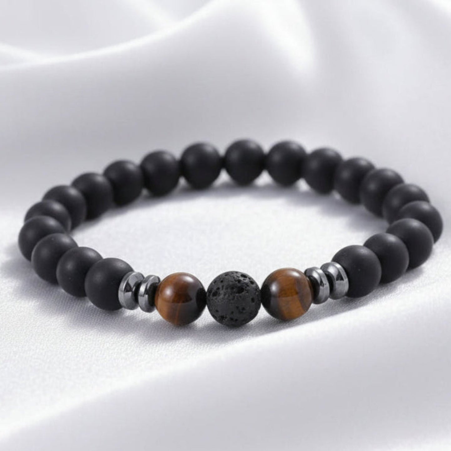 Black beaded bracelet with brown and silver beads on a white surface