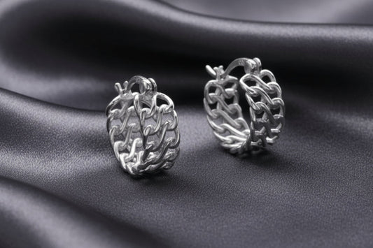 Pair of silver chain hoop earrings on a light gray background