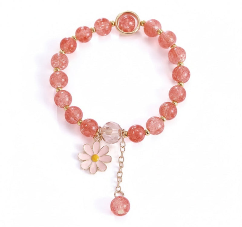 Bracelet with pink beads and a floral charm on a light background