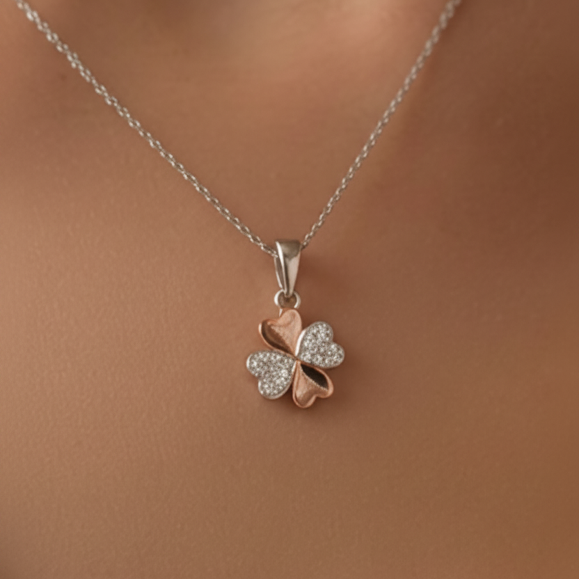 Sterling silver and rose gold plated clover pendant on a chain on a model
