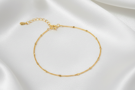 Gold bracelet on a white background