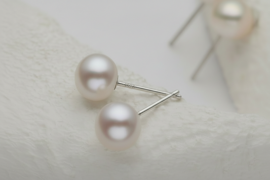 Pearl earrings on a light gray background