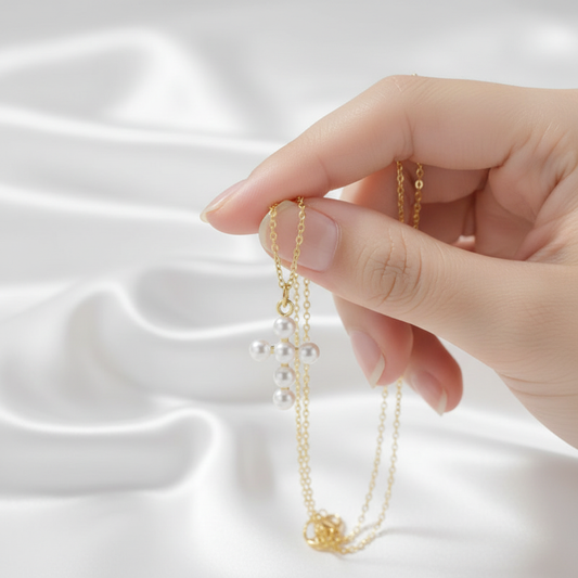 Pearl cross necklace - held in hand