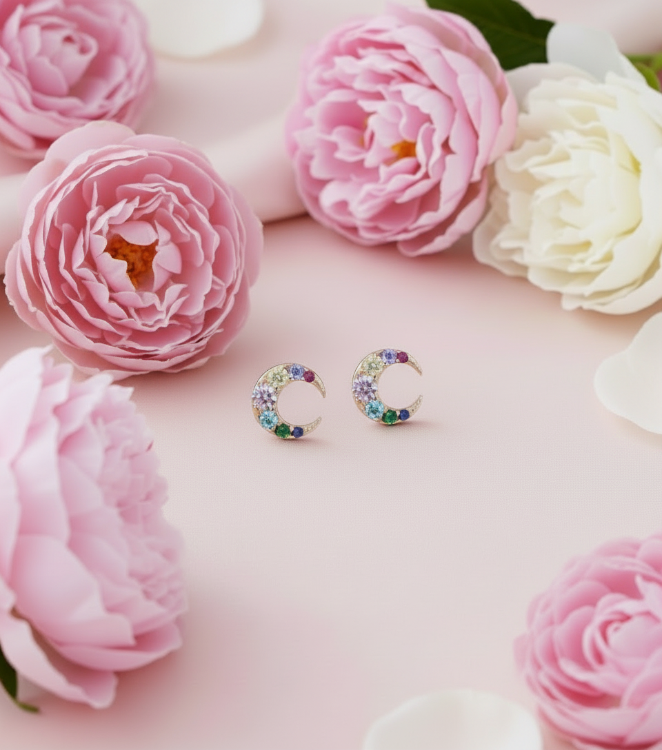 sun moon jewellery, bracelet, earrings and necklace on a pink background