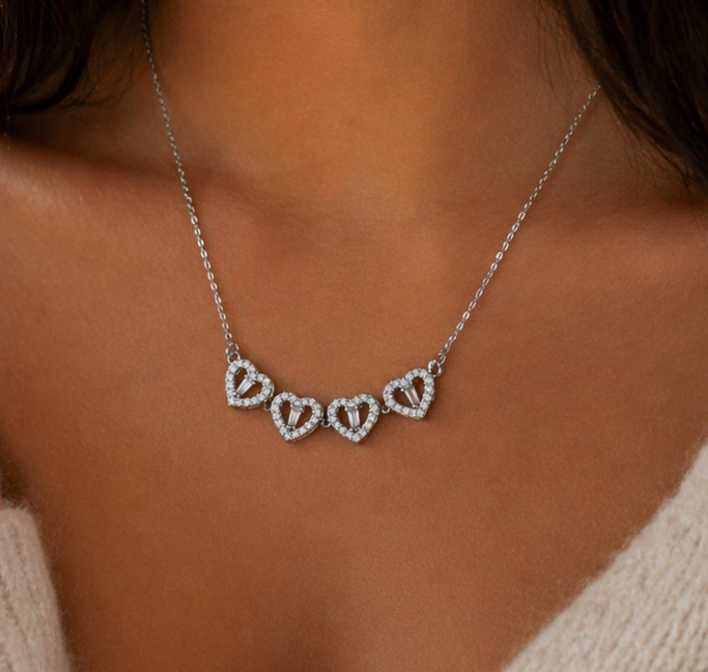 Necklace with heart-shaped pendants worn by a person