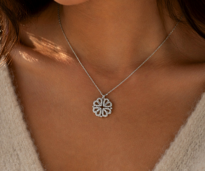 Close-up of a person wearing a silver necklace with a circular pendant.