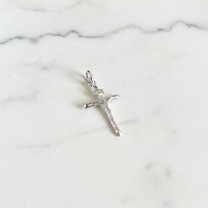 Silver plain crucifix flat lay on white marble