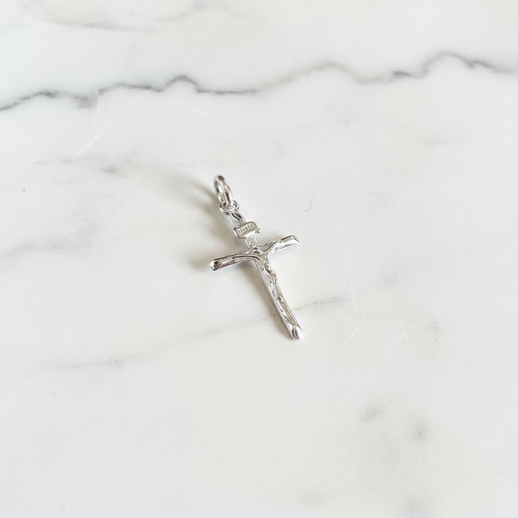 Silver plain crucifix flat lay on white marble