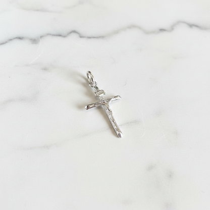 Silver plain crucifix flat lay on white marble
