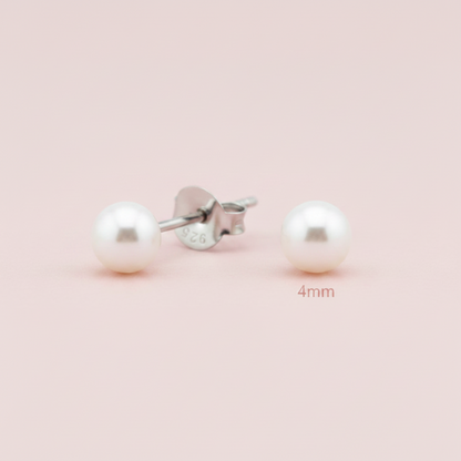A pair of 4mm round white pearl stud earrings with silver posts, one shown from the front and the other from the side/back. The silver post is stamped with '925' and '926' sterling silver markings.