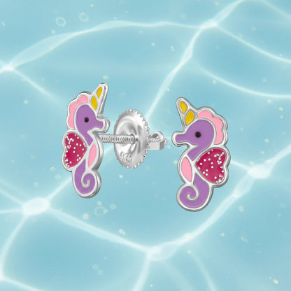 A pair of rhodium-plated stud earrings shaped like purple and pink seahorses with yellow and white accents, shown on a white background with a close-up of the screw-back post.