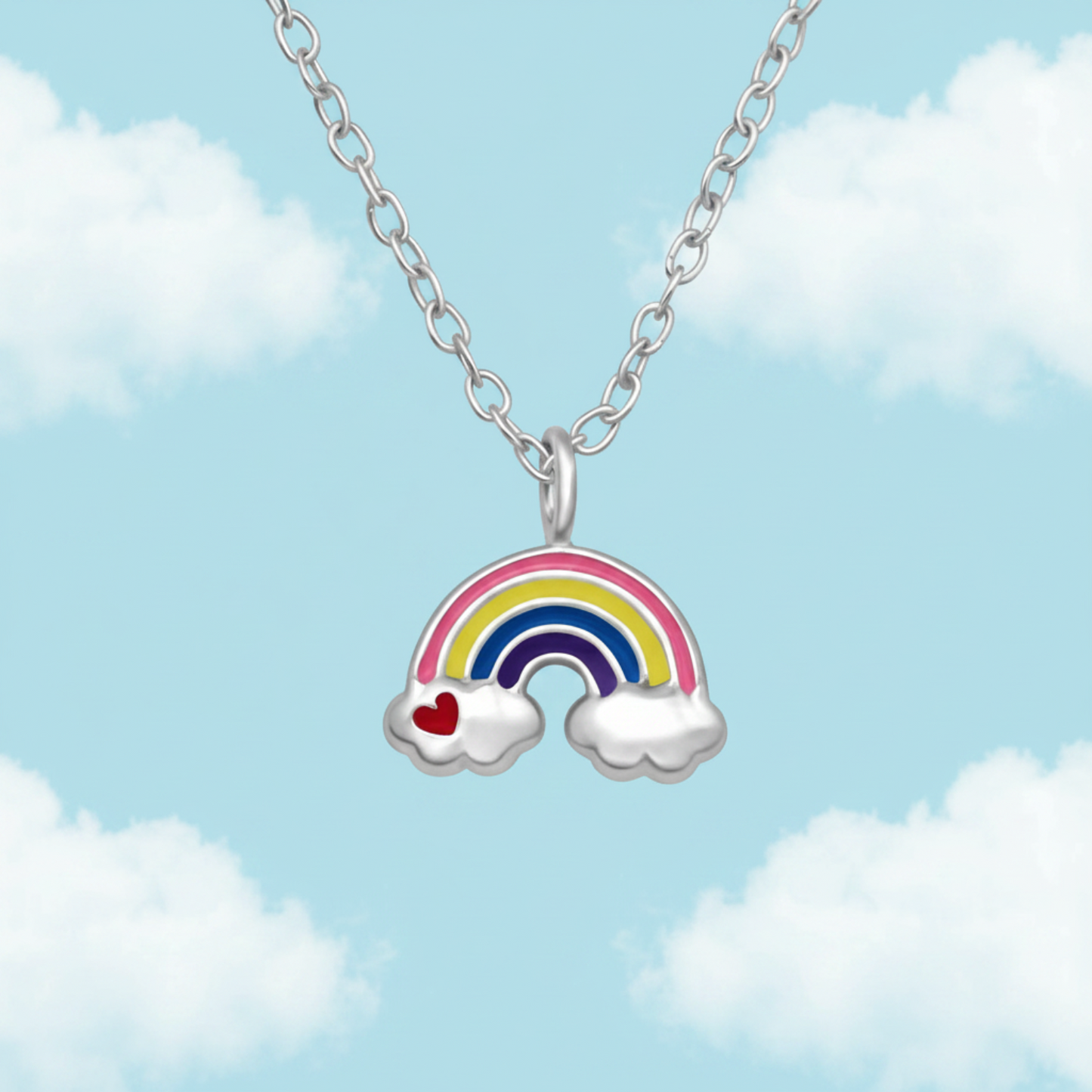 A silver chain necklace with a rainbow cloud pendant, featuring a silver rainbow with pink, yellow, green, blue, and purple enamel stripes, white cloud ends, and a small red heart on one cloud.