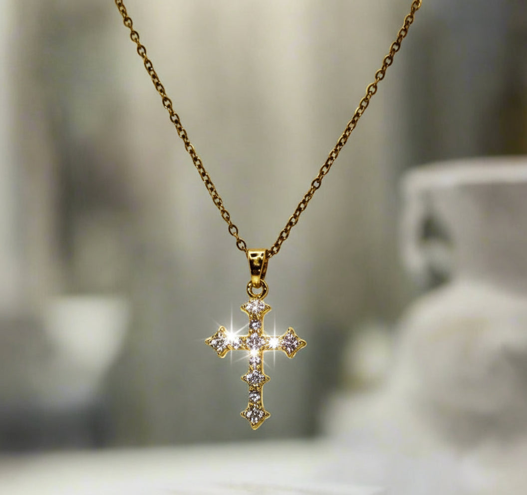 Gold cross necklace on a white bust
