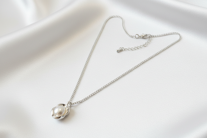 Silver necklace with a pearl pendant on a white background