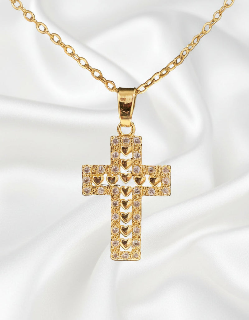 Gold cross pendant necklace on a black background