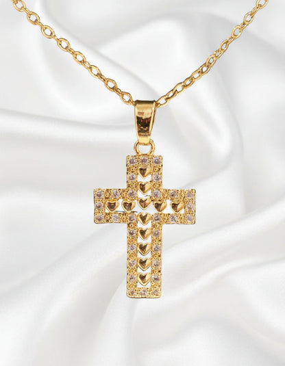 Gold cross pendant necklace on a black background