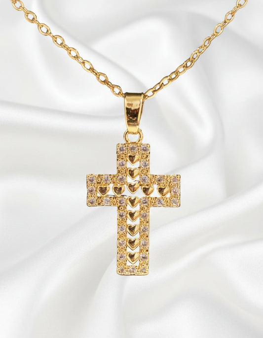 Gold cross pendant necklace on a black background