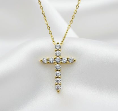 Gold cross pendant necklace with diamonds on a white background