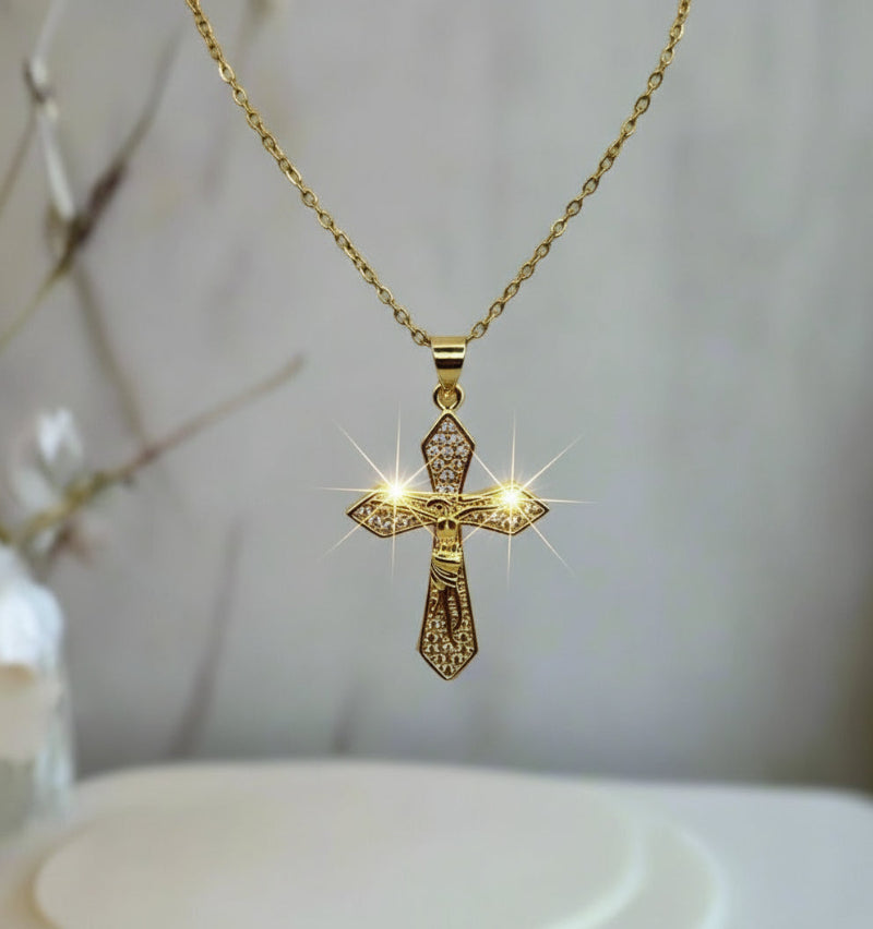 Gold cross pendant necklace on a blurred background
