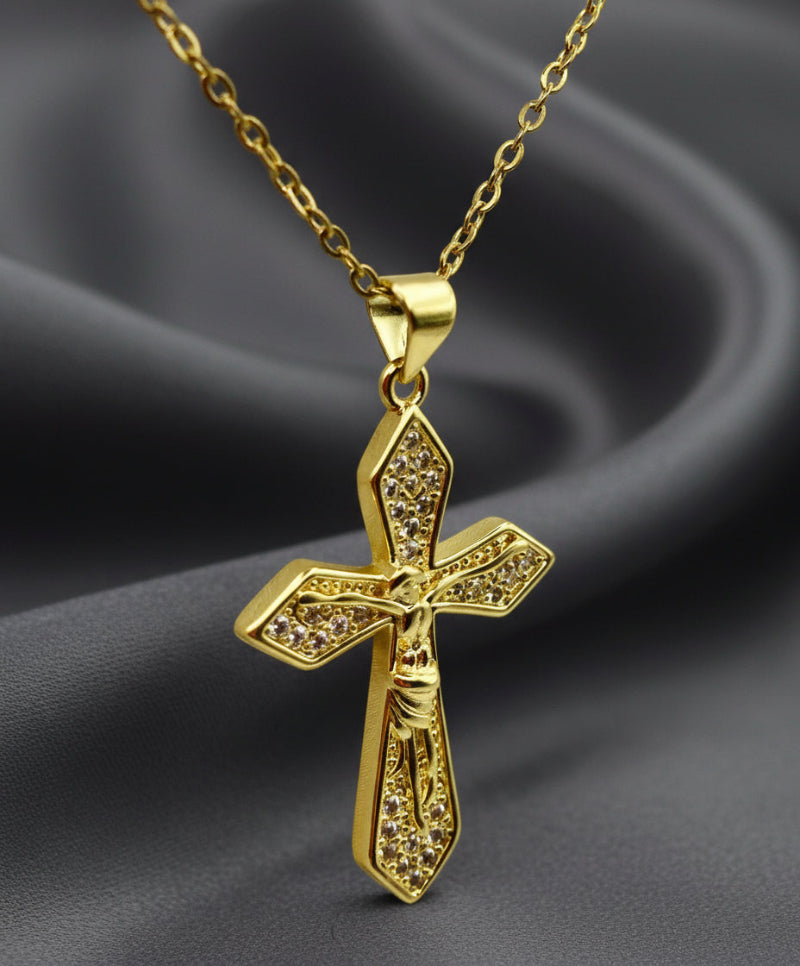 Gold cross pendant necklace on a white background