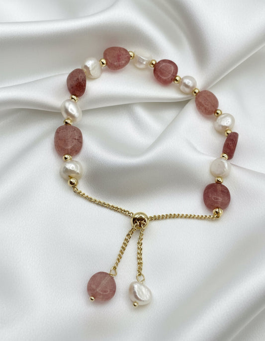 Bracelet with pink and white beads on a white background