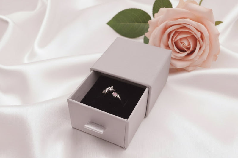 silver cat ring with pink heart zircon in grey box on while background