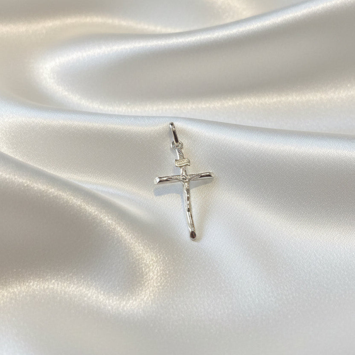 925 sterling silver crucifix cross pendant rhodium plated, front view on white background