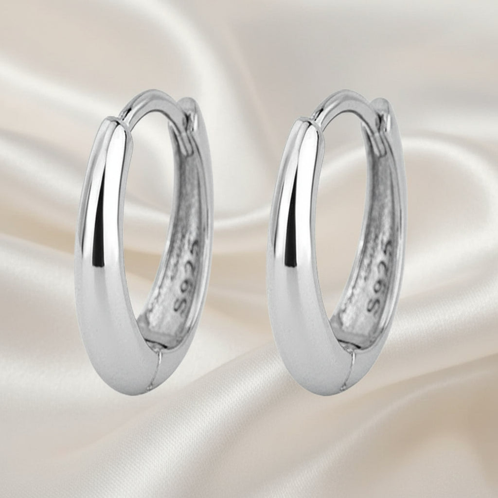 Pair of silver hoop earrings on a white background