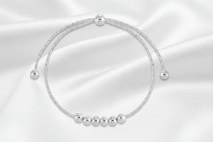 Silver beaded bracelet on a white background