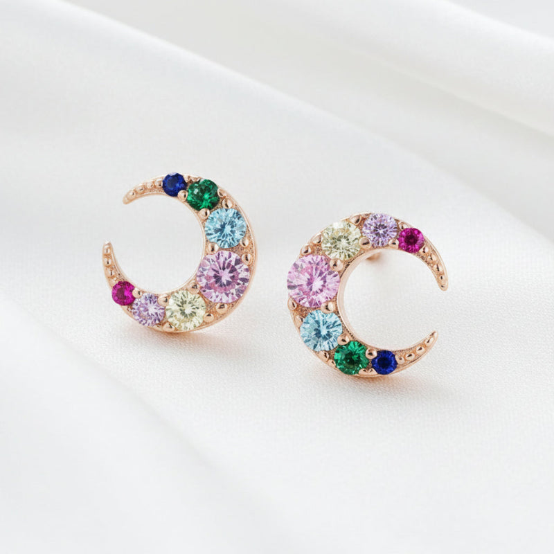 Colorful crescent moon-shaped earrings on a white background