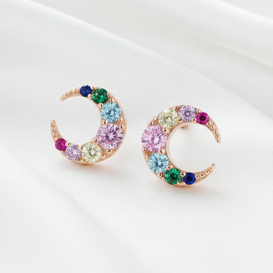Colorful crescent moon-shaped earrings on a white background