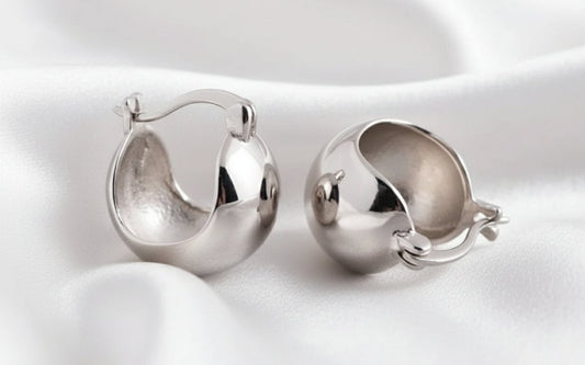 Pair of silver hoop earrings on a white background
