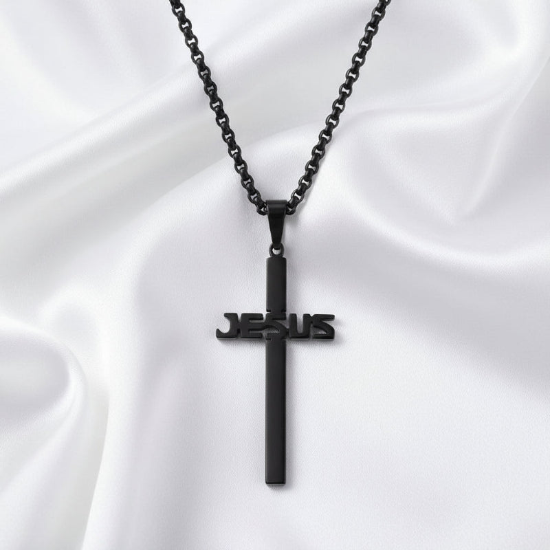 Black cross pendant with 'JESUS' engraving on a white background
