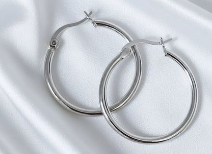 Pair of silver hoop earrings on a white background