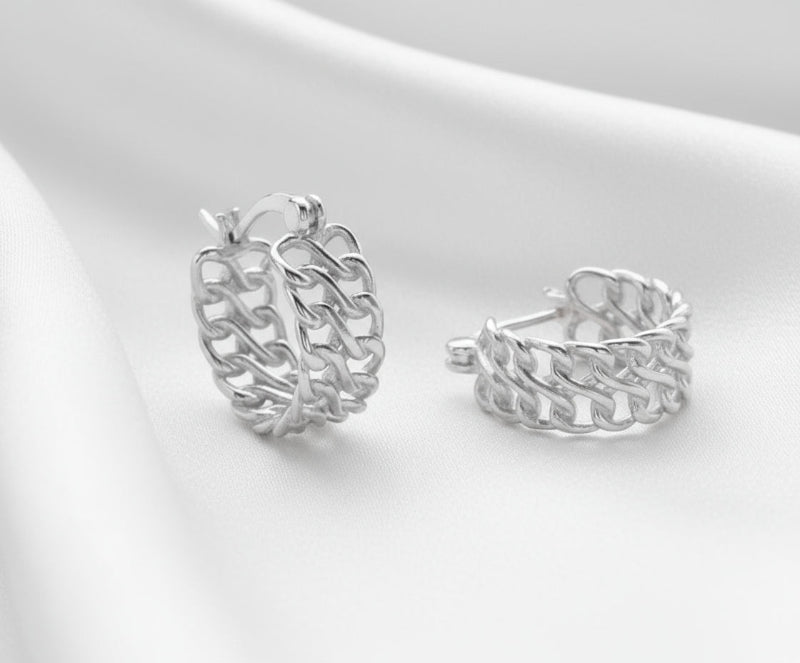 Pair of silver hoop earrings on a light gray background