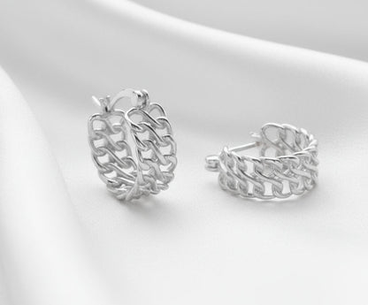 Pair of silver hoop earrings on a light gray background