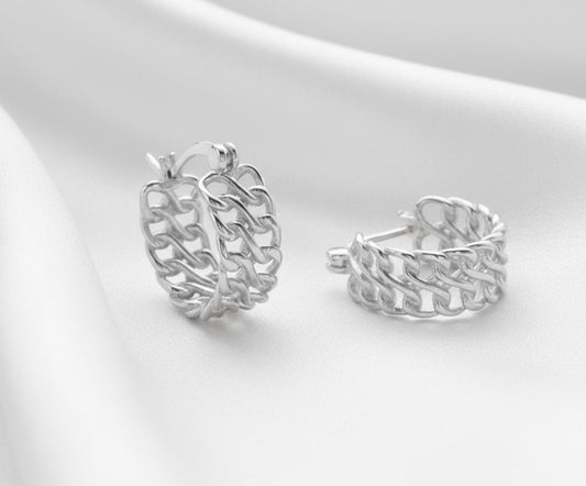 Pair of silver hoop earrings on a light gray background