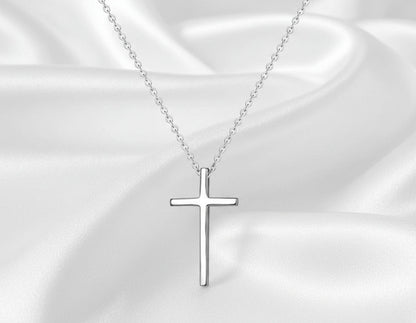 Silver cross necklace on a white background