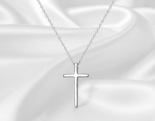 Silver cross necklace on a white background