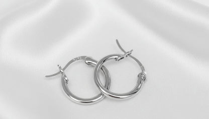 Pair of silver hoop earrings on a white background