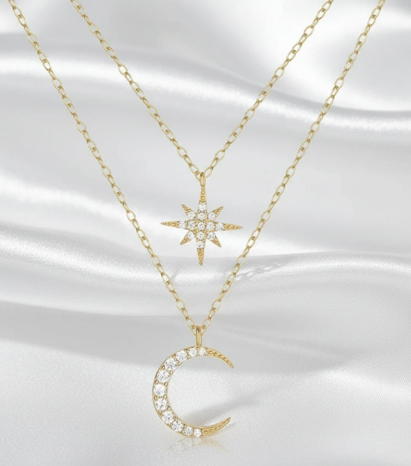 Two gold necklaces with star and moon pendants on a white background