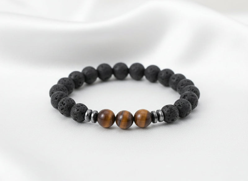 Black beaded bracelet with brown and silver beads on a white surface