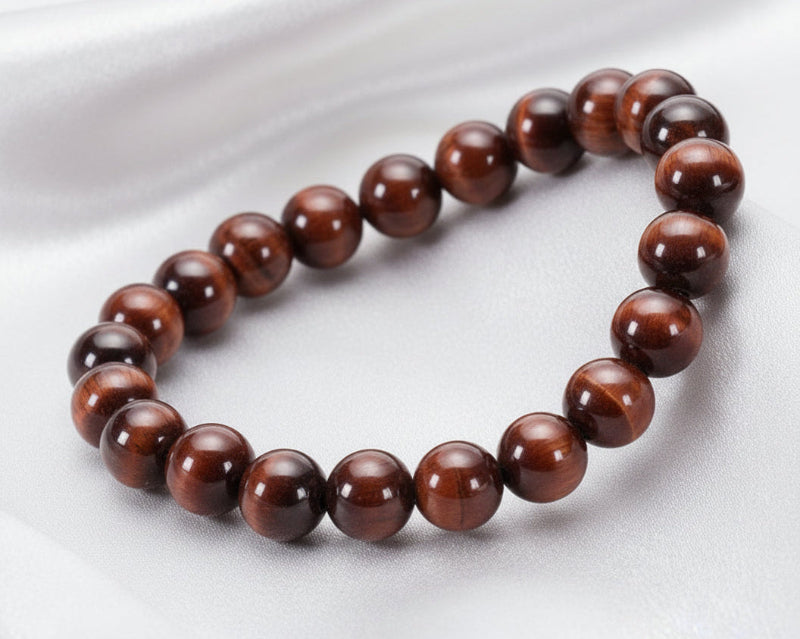 Bracelet made of natural red tiger eye beads on a white background