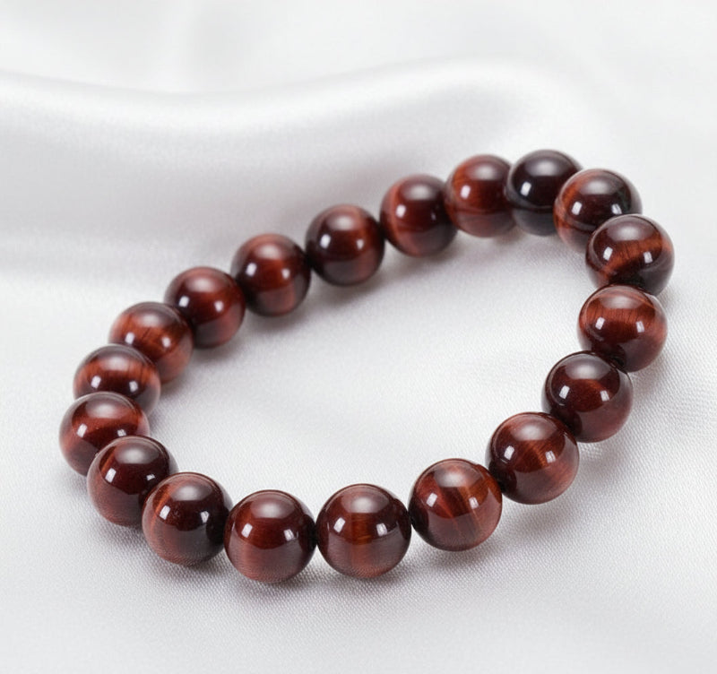 Beaded bracelet made of natural red tiger eye on a white surface