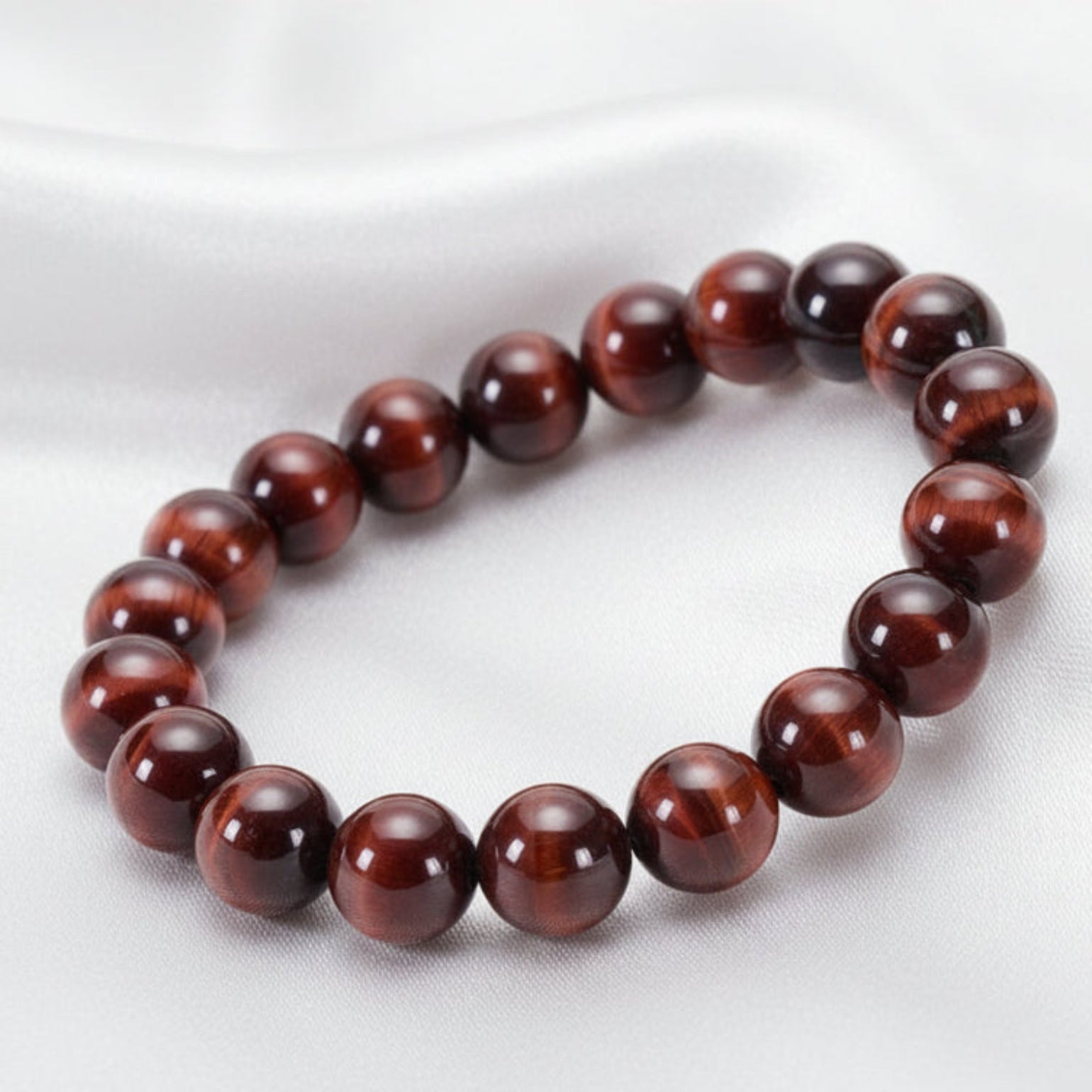 Beaded bracelet made of natural red tiger eye on a white surface