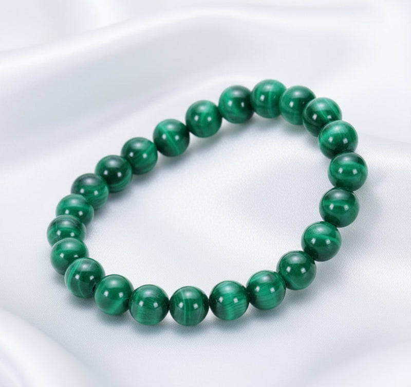 Green beaded bracelet on a white surface 